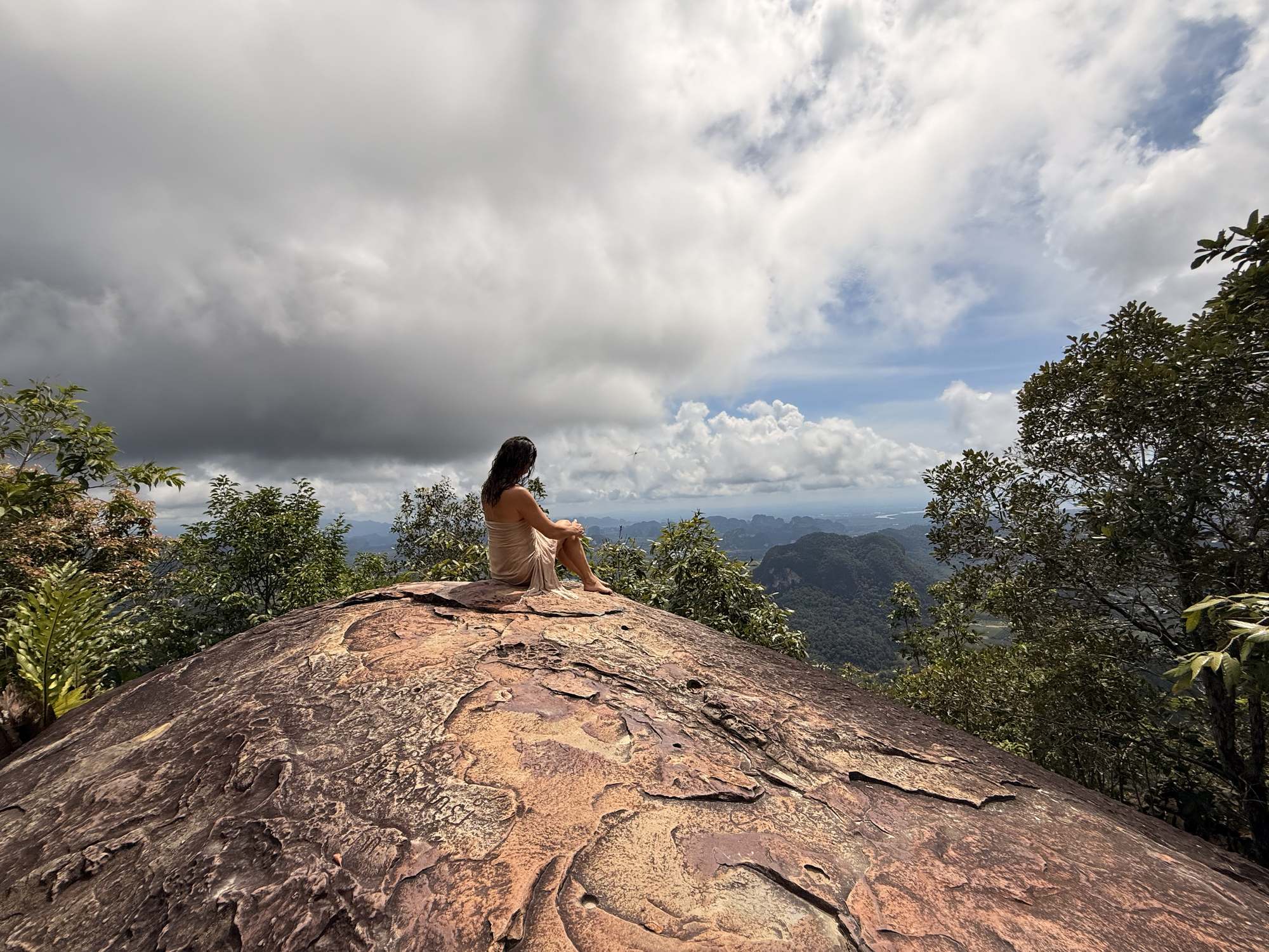 Christina sitting on a rock high above Krabi
