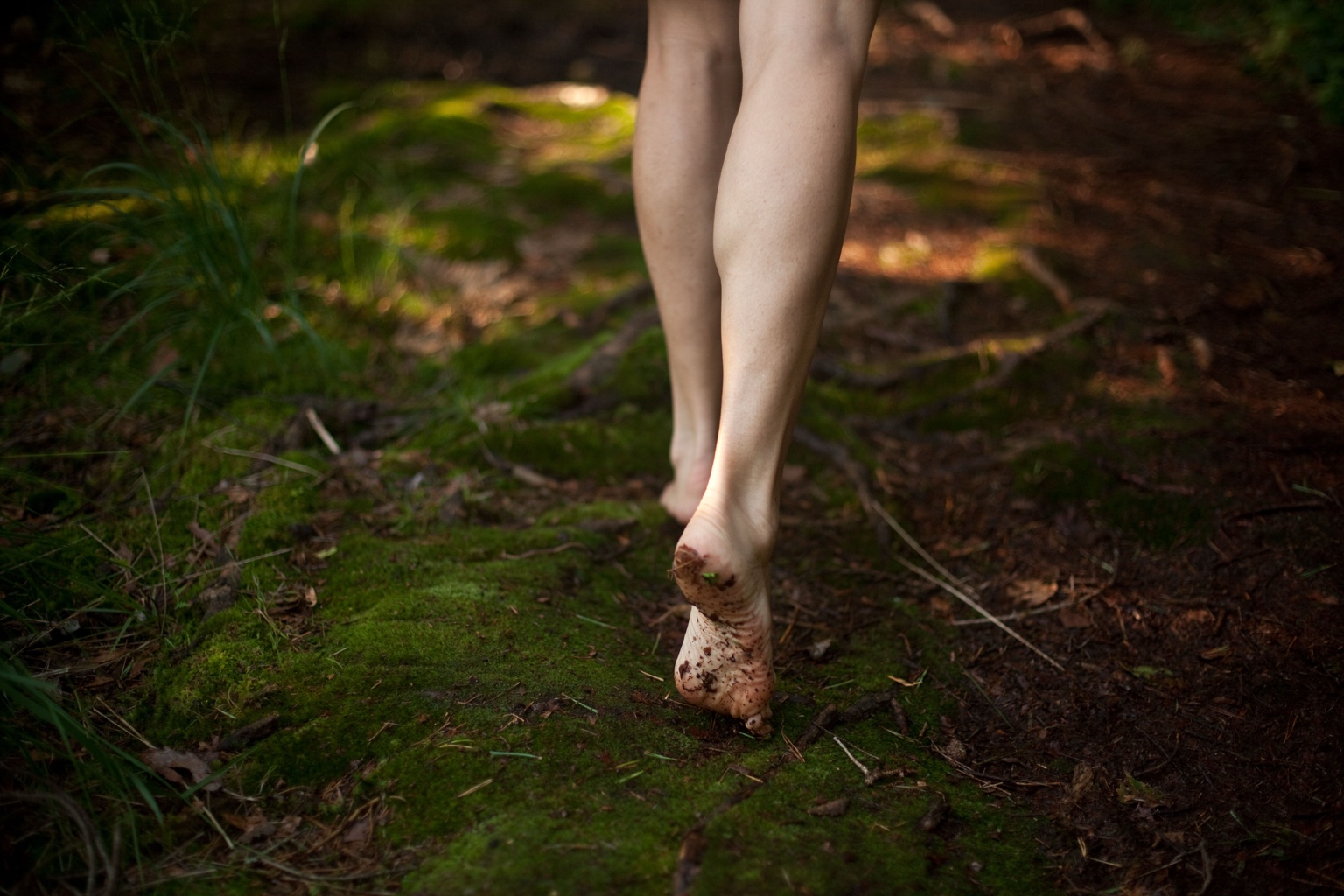 Barefoot over moss in the forest